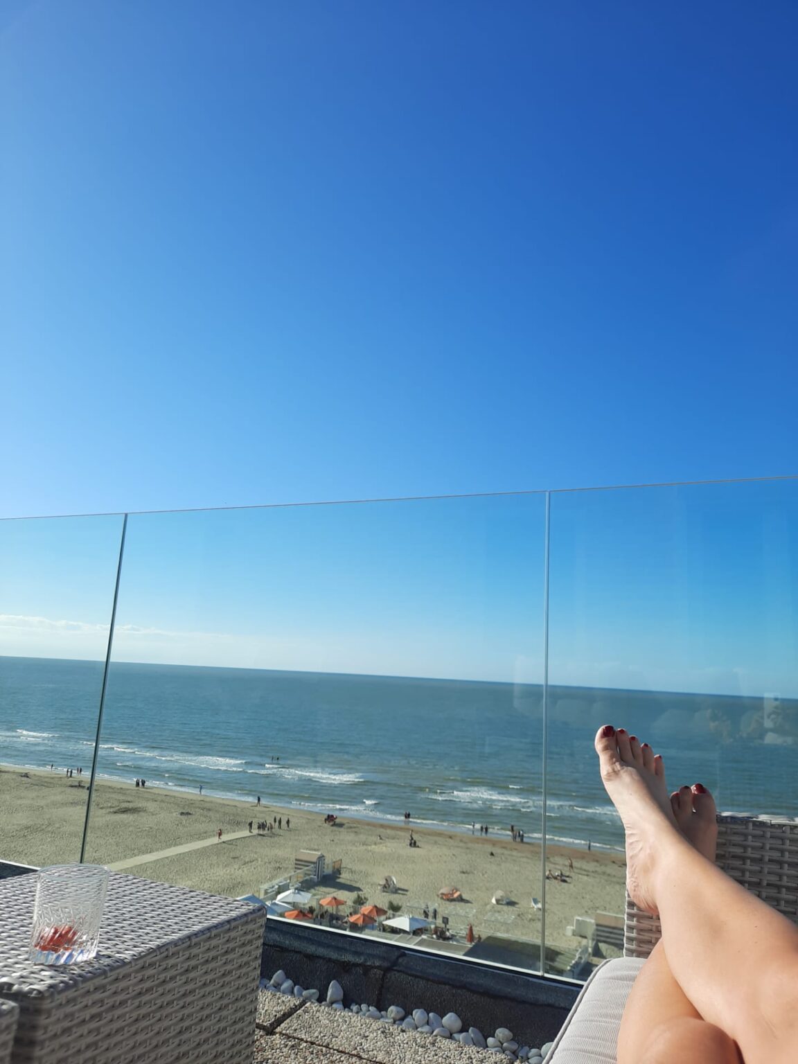 Dame ligt te zonnen bij nieuwe glazen balustrade